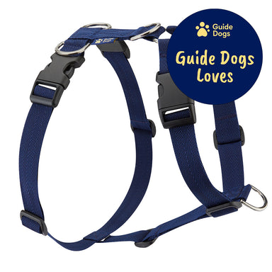 A close up of a navy dog harness with the Guide Dogs logo. The Guide Dogs Loves logo is in the top right.
