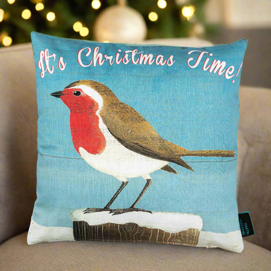 A cushion with illustrated robin in the snow on a blue background, with the words 'It's Christmas Time!' across the top.