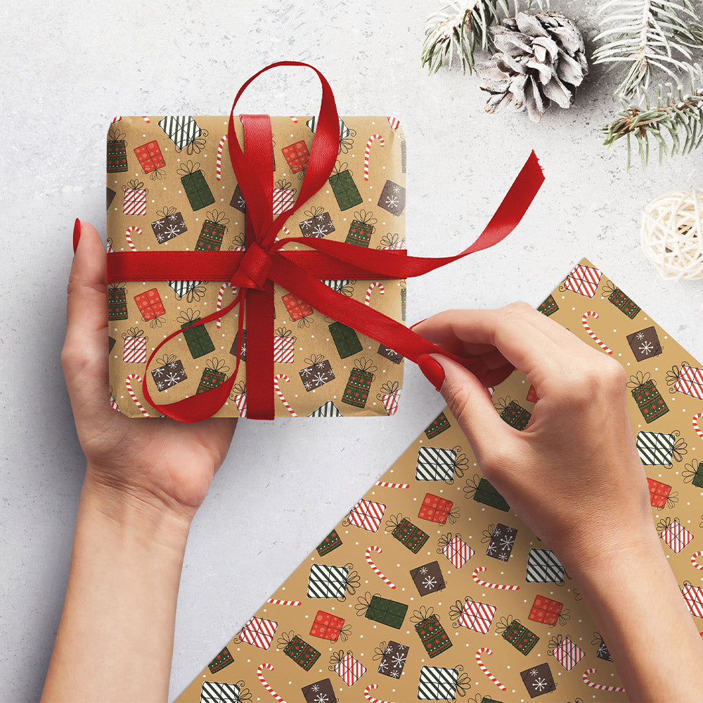 A woman's hands holding a wrapped present with another piece next to her. The wrap is brown with illustrations of candy canes and festive presents.