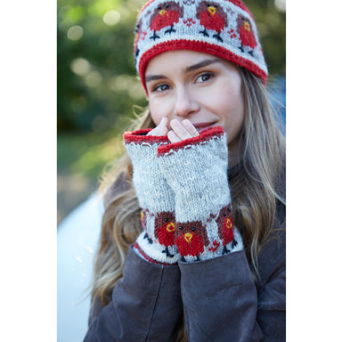 A girl wears Pachamama Robin Hand Warmers and a matching Pachamama Robin Headband.