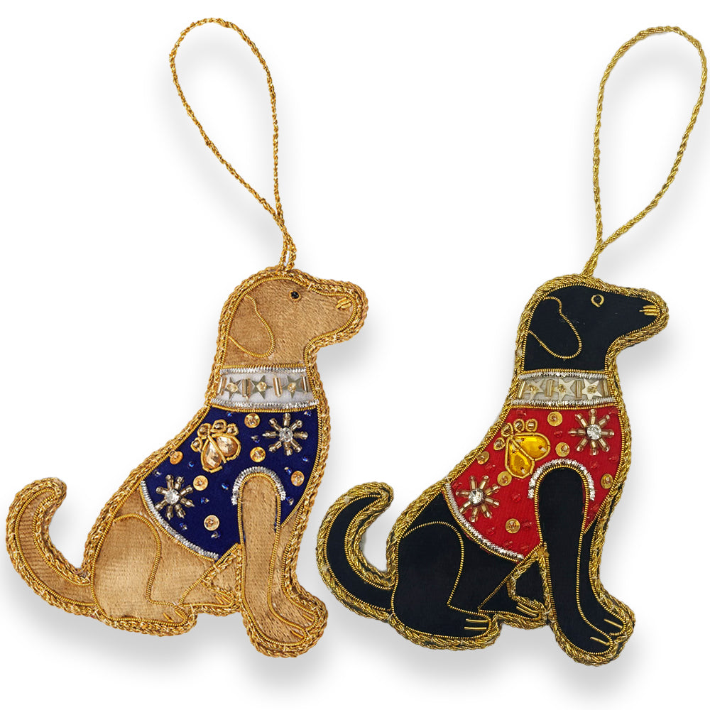 Two fabric Labrador decorations, one yellow with blue embellished jacket and one black with red embellished jacket with hanging loops