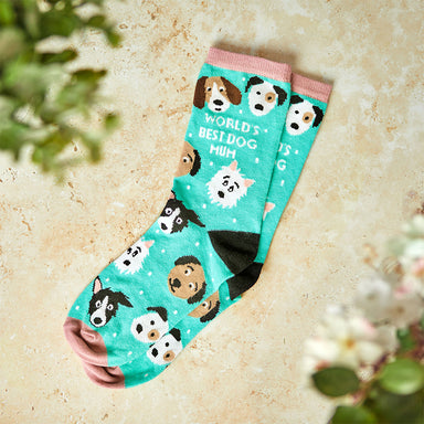 A pair of blue socks featuring illustrations of dogs and the words 'World's Best Dog Mum'.