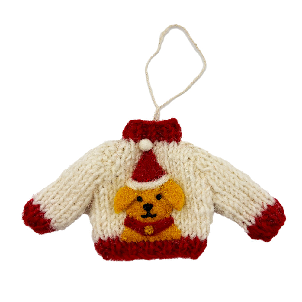 A white knitted decoration with red edges, in the shape of a jumper. It features a golden Labrador wearing a Santa hat.