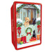 A photograph of a biscuit tin featuring two Labradors peeking over a gate at a festive scene including a black cat.