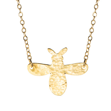 A close-up of the Fair Trade Hammered Brass Bee Necklace.