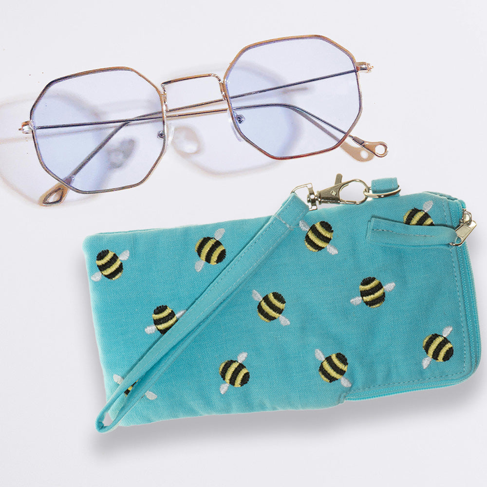 A close-up of the Fair Trade Bee Glasses Case with a pair of glasses next to it