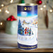 A close-up of the Guide Dogs Christmas Eve Village - Chocolate Chip Biscuits. A village celebrating Christmas is used as packaging wrap around the cylindrical biscuit tin.