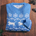 A folded blue and white jumper on a wooden background, with Guide Dogs inner neck logo label visible.