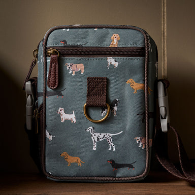 A rectangular bag printed in dog pattern with brown trims and webbing strap