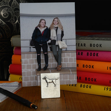 Pewter photo holder shown with family photo and books behind it