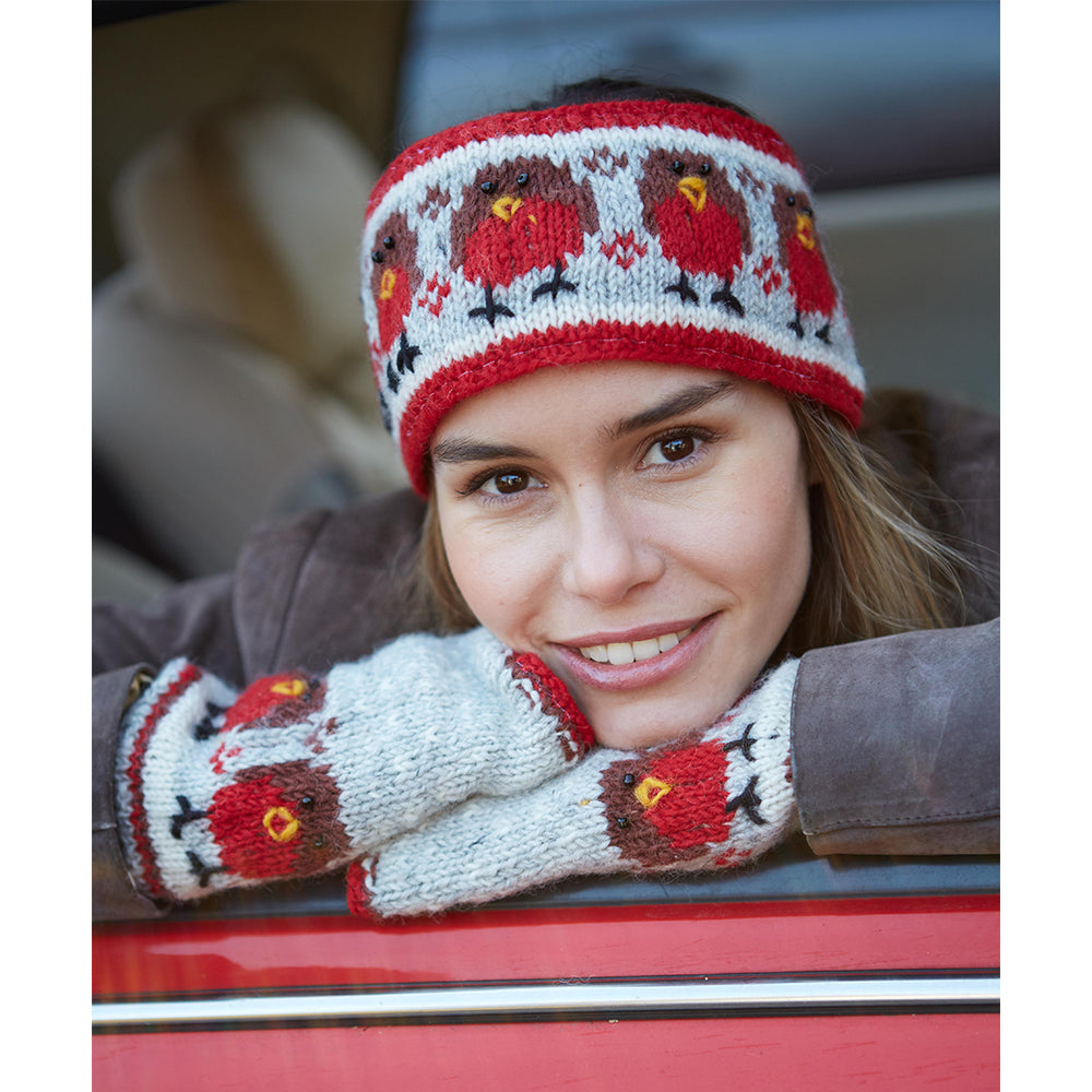 A lady looks out of a car wearing the Pachamama Robin Handwarmers and the matching Pachamama Robin Headband.