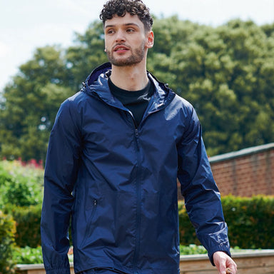 A man walks outside wearing the Men's Regatta Packable Waterproof Jacket.