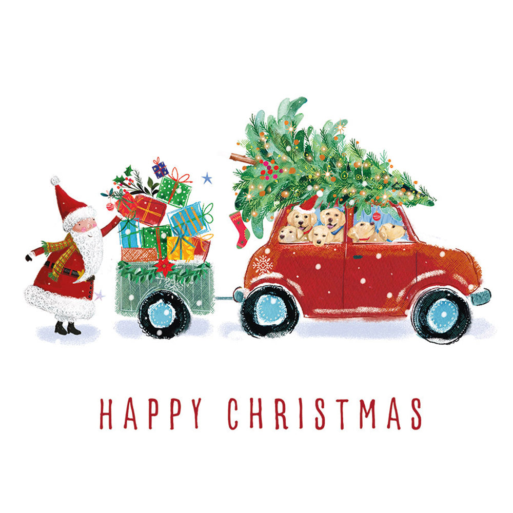 An illustration of a red car containing six yellow Labrador puppies has a Christmas tree attached to the top. The car is pulling along a trailer filled with multicoloured wrapped gifts. Father Christmas is stood behind the trailer holding a present. The text ‘Happy Christmas’ appears below in red.