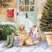 An illustration of a Golden Retriever and Jack Russell Terrier sat in front of a festive doorway. There is also a pair of welly boots with a robin on top next to the dogs.