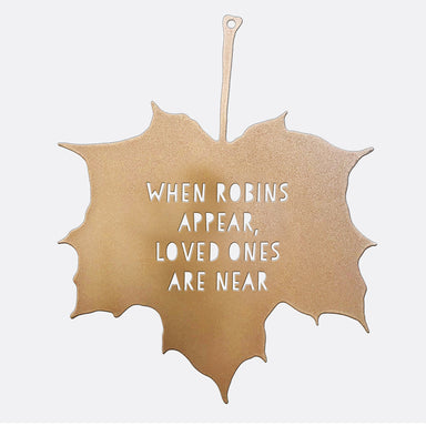 A closeup of the Decorative Garden Leaf. A metal leaf ornament with the lettering 'When Robins Appear, Loved Ones Are Near' is set against a white background.