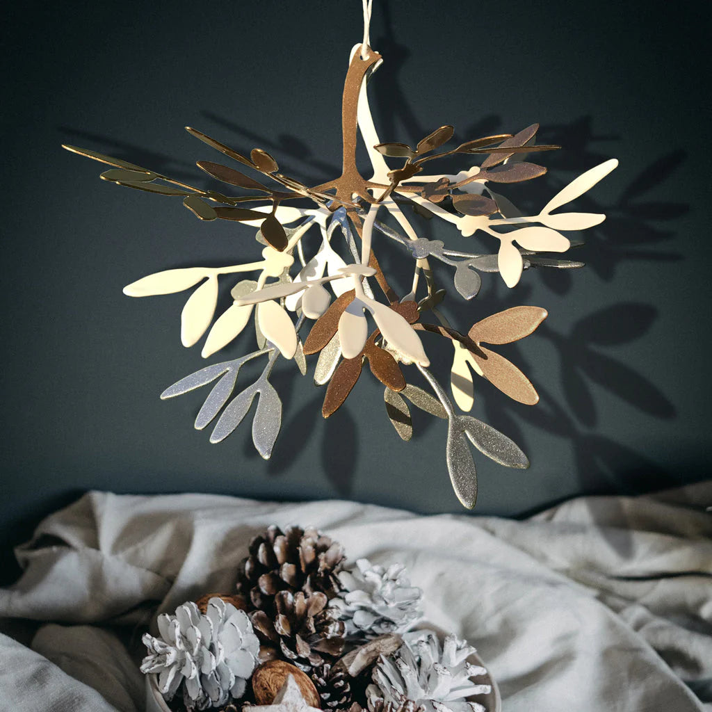 Gold, silver and white mistletoe branch decoration shown hanging up