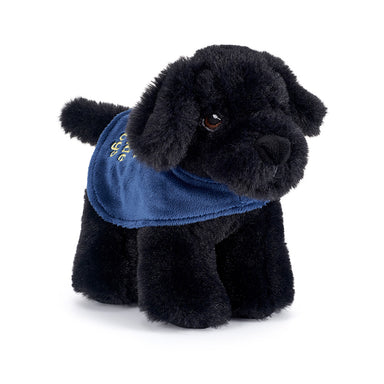 A small Black Labrador soft toy wearing a blue Guide Dogs coat.