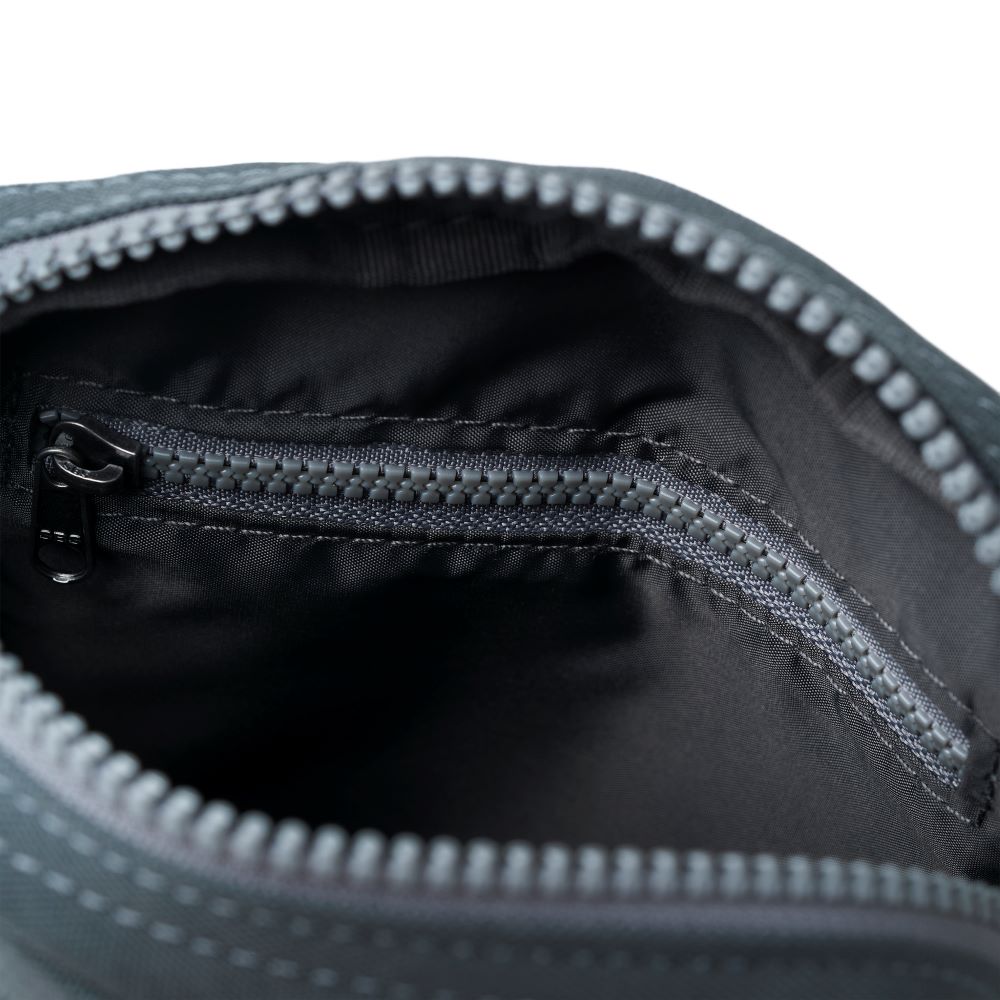 A close-up of the bag's open top zip and inner zip.