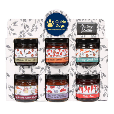 A Guide Dogs branded container featuring six chutneys in small jars with the text 'Chutney Selection' at the top right corner.