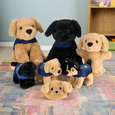 A group of soft toy dogs including two large toys, three small toys, a puppy hand puppet and a soft purse.