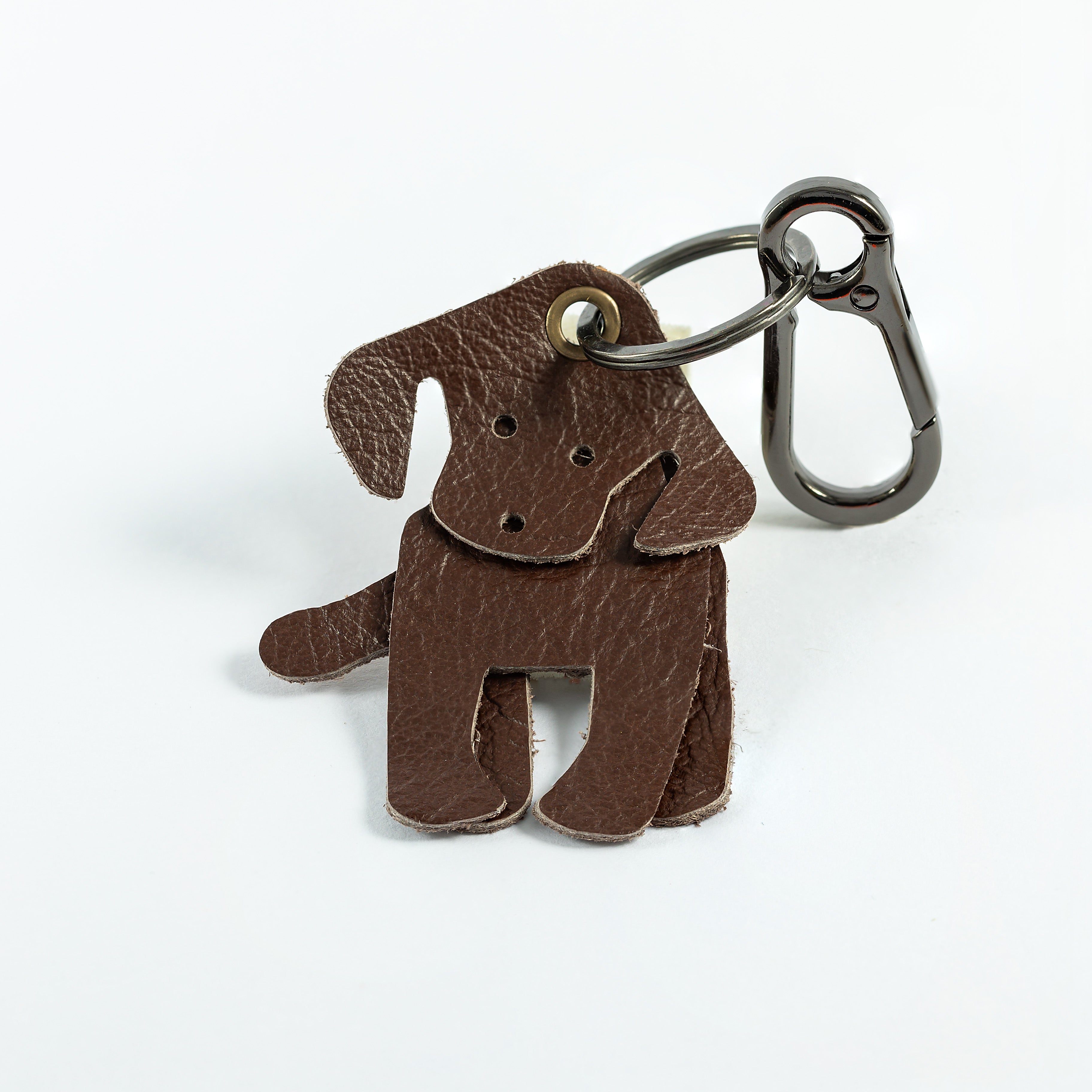 A brown leather keyring in the shape of a Labrador, with metal loop  for keys