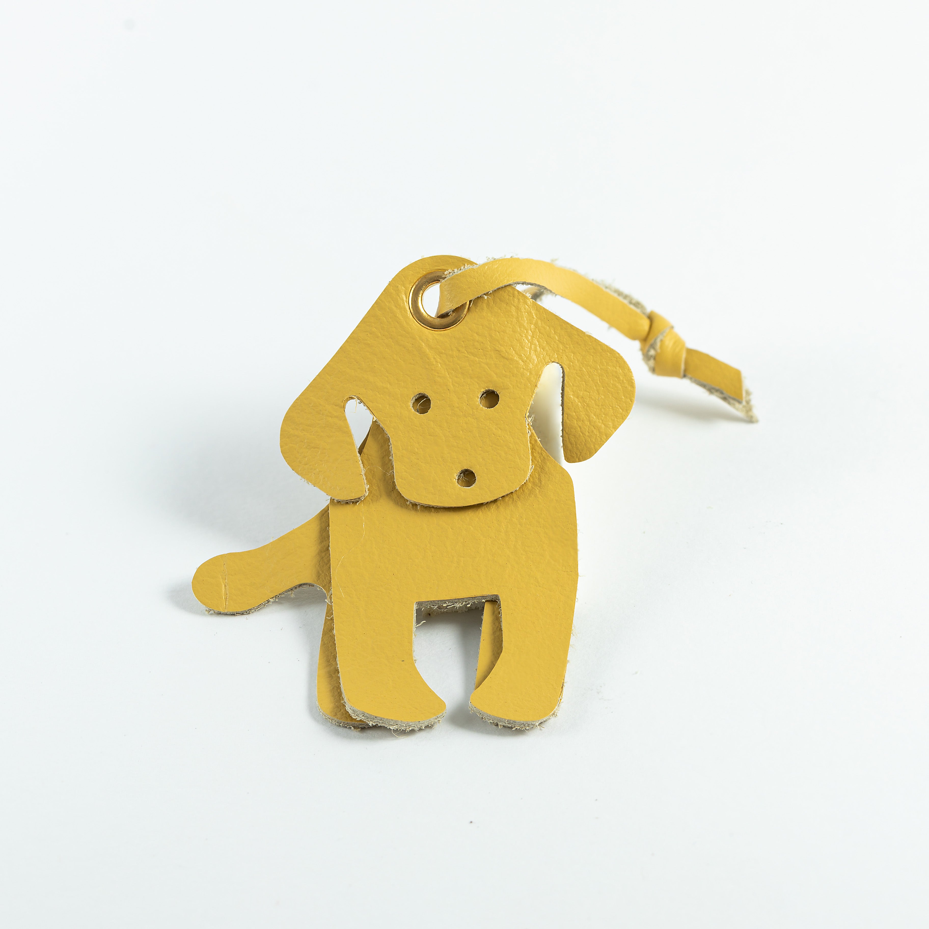 A yellow leather Labrador-shaped bookmark with loop.