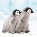 A Christmas card design with a photograph of 2 baby penguins in the snow.