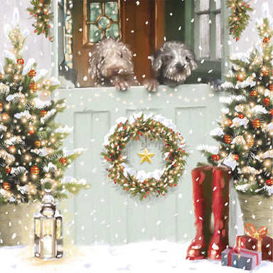 A Christmas card with an illustration of a stable door decorated for Christmas, the bottom portion of the door is closed. 2 scruffy dogs are poking their heads over the door.
