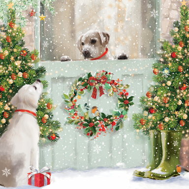 The design is an illustration of a dog peeping over a barn door, looking at a another dog. There is a wreath on the barn door and Christmas trees either side.