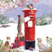 The design shows an illustrated snowy country setting and three tabby cats around a postbox with one posting a letter. There are a group of presents besides the postbox and a yellow Labrador puppy and robin looking on.
