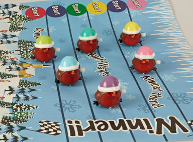 Plastic wind-up racing robins on a blue track decorated with snowflakes.