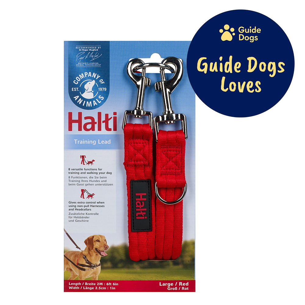 The Halti Training lead in its packing - the end of the lead and its silver clips are wrapped around a blue piece of cardboard featuring a picture of a dog wearing the lead. The Guide Dogs Loves logo is in the top right.