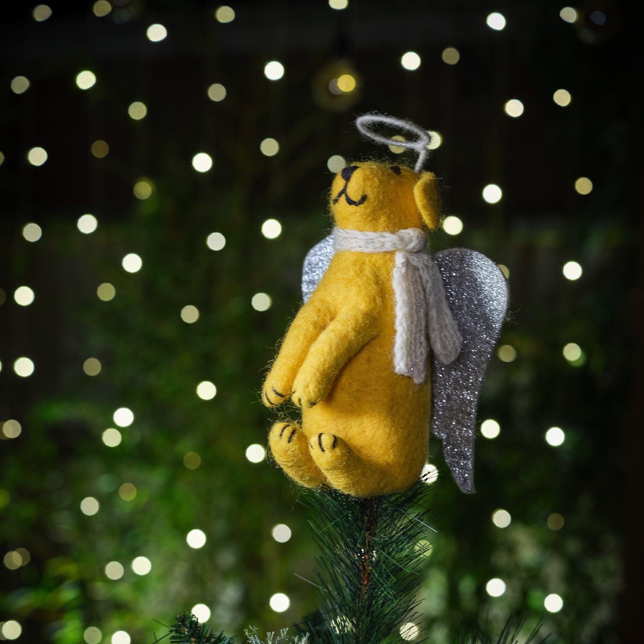 A close up of a Yellow Labrador Christmas tree topper with a silver halo and wings.