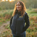 A lifestyle image of a woman wearing the Guide Dogs branded body warmer.