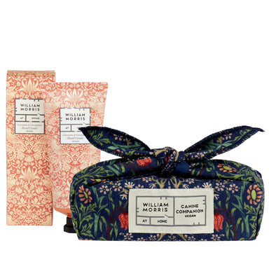A tube of hand cream with floral William Morris design, next to a fabric bandana