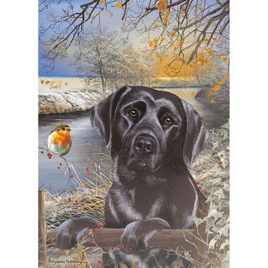An image of the design on the jigsaw showing a Black Labrador climbing onto a fence with its two front paws. A robin sits on a brand and a river runs behind them. 