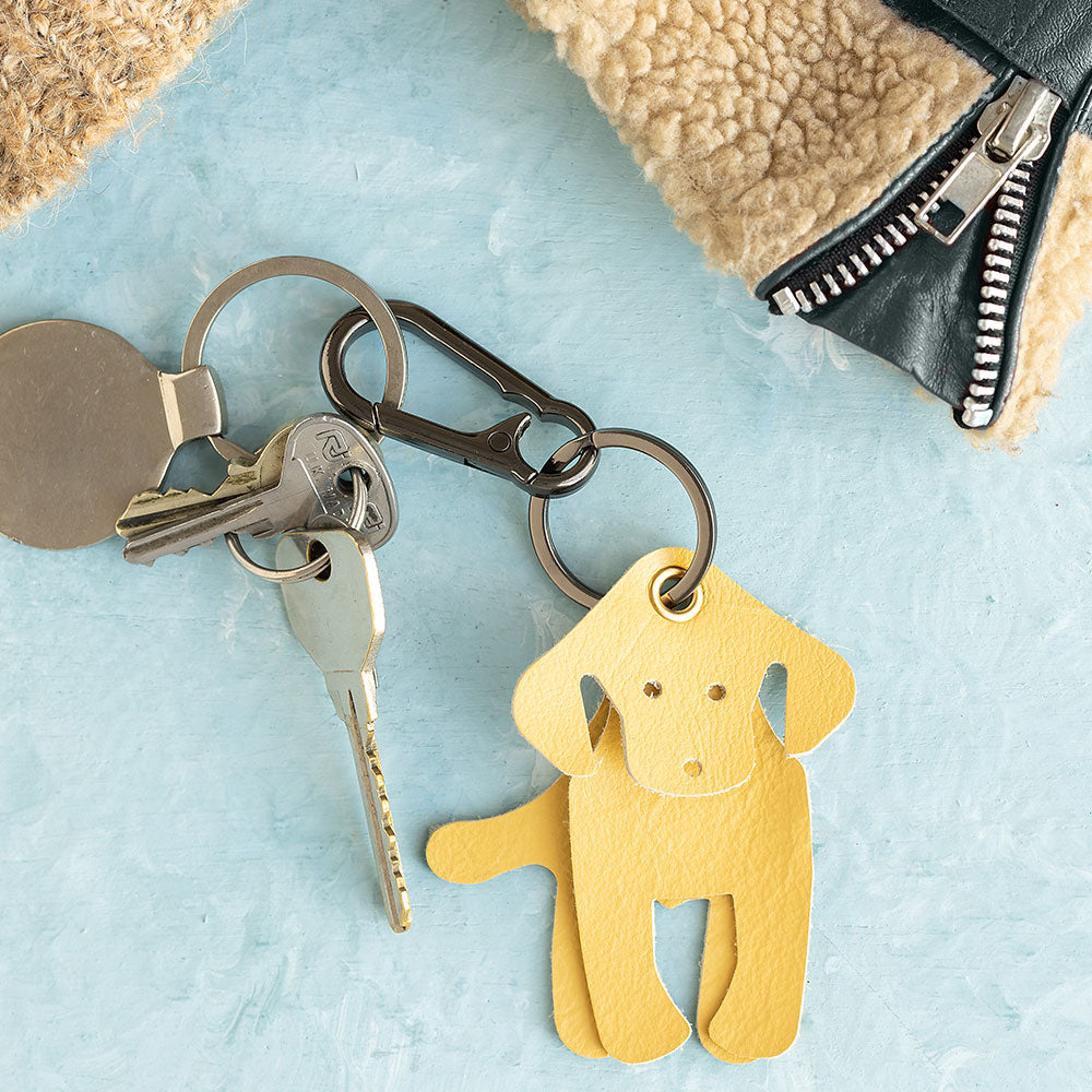 A yellow leather Labrador-shaped keyring with metal loop