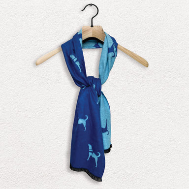 A Guide Dogs branded scarf in two shades of blue hangs on a wooder clothes hanger against a white textured background.