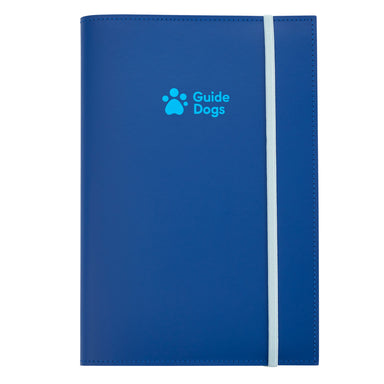 A close up of a blue leather journal. The Guide Dogs logo is printed on the front in light blue and a piece of white elastic holds it closed.