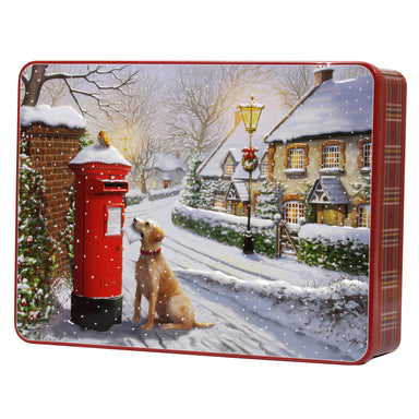 A close up of a biscuit tin, the lid is decorated with an illustration of a snowy scene outside out a house. A Yellow Labrador is sat at a postbox with a letter in it's mouth looking at a robin sat on the letterbox. A red tartan print decorates the sides of the tin.