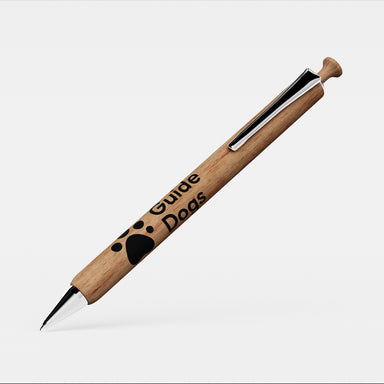 A close up of a pen with a wooden barrel and clicker and silver clip and tip. The wooden barrel has the Guide Dogs logo in black.