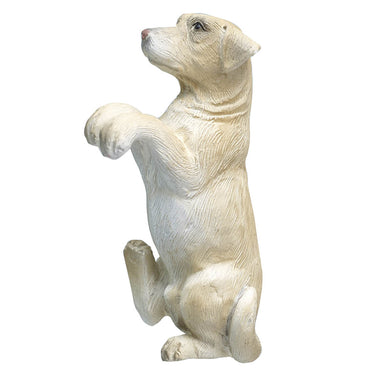 A resin Yellow Labrador sat on one foot with its front paws up.